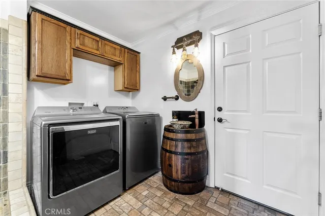 a kitchen with stainless steel appliances granite countertop a stove a washer and dryer