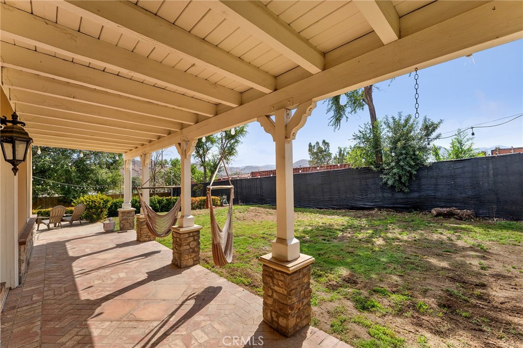 31800 3rd Street Acton, CA 93510 - Photo 33 of 47 a view of a patio with table and chairs potted plants with wooden floor and fence