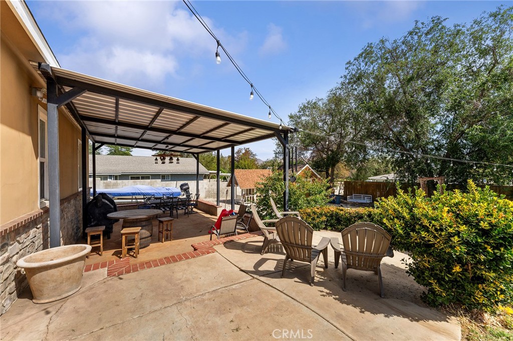 31800 3rd Street Acton, CA 93510 - Photo 35 of 47 a view of a patio with table and chairs under an umbrella