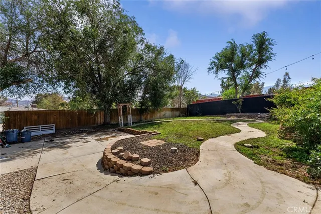 a view of a backyard with sitting area