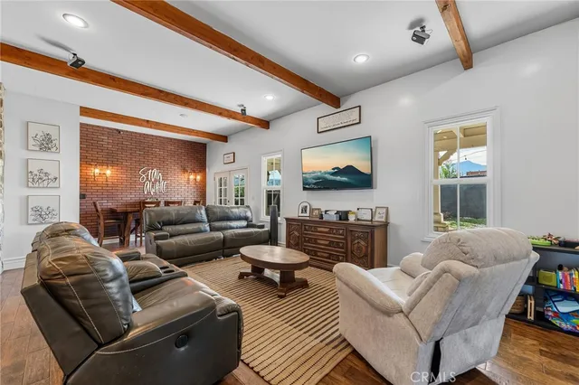 a living room with fireplace furniture and a flat screen tv