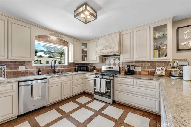 a kitchen with a sink cabinets and window