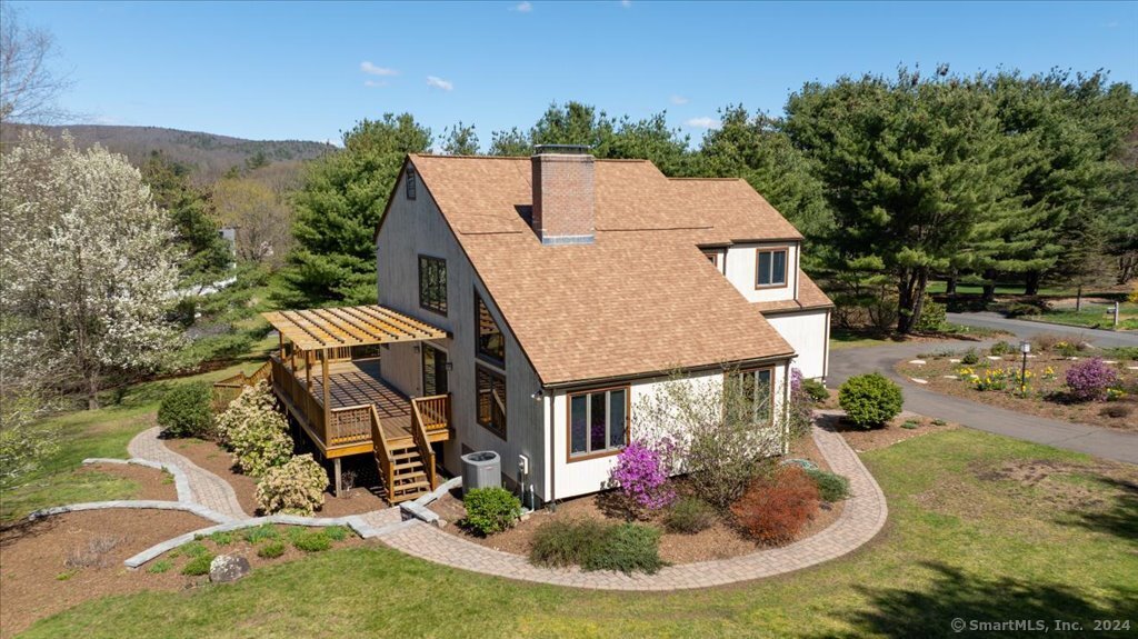 aerial view of a house with a yard patio and fire pit