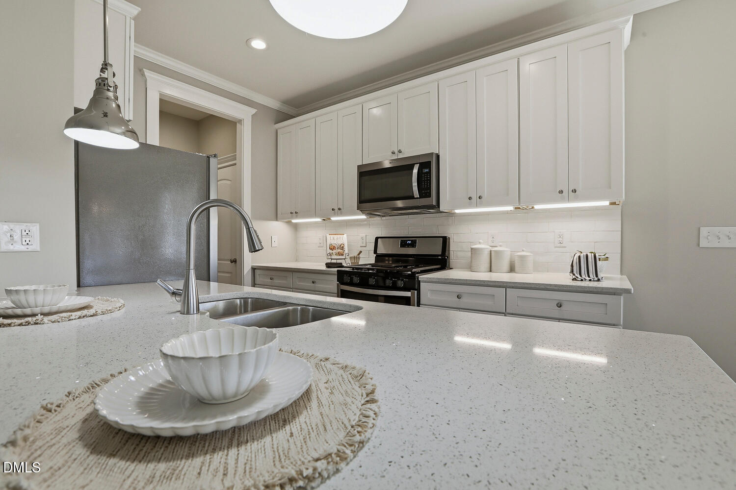 1605 Boyer Street Raleigh, NC 27610 - Photo 11 of 38 a kitchen with a sink a stove and cabinets