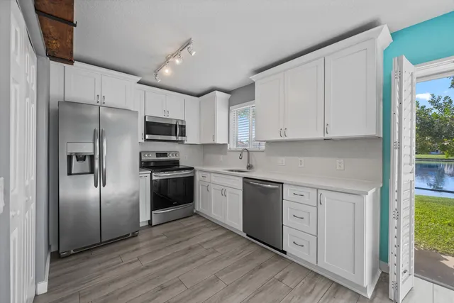 a kitchen with cabinets and stainless steel appliances
