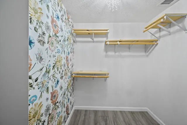a living room with couches and kitchen view