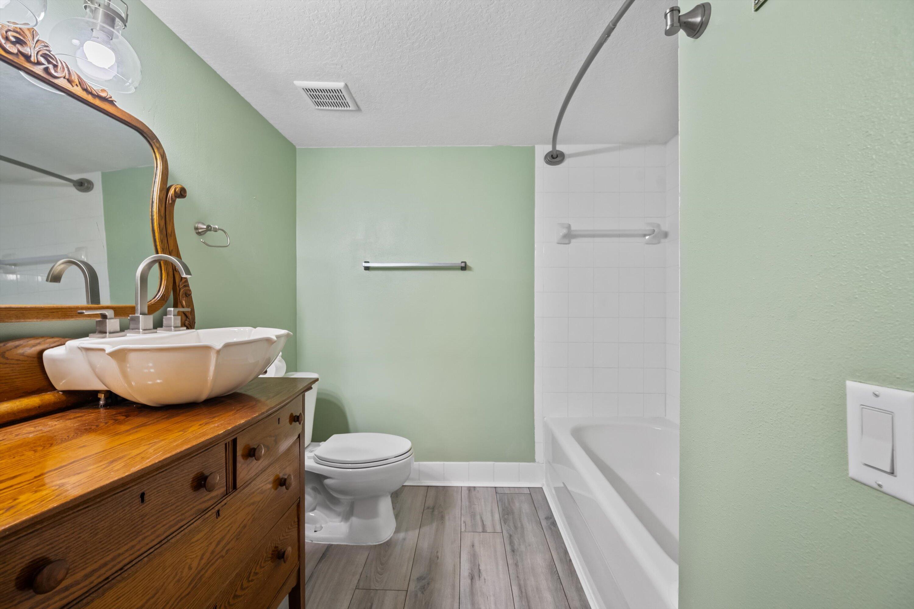 3486 Briar Bay Boulevard, Unit 101 West Palm Beach, FL 33411 - Photo 30 of 46 a bathroom with a sink a toilet and shower