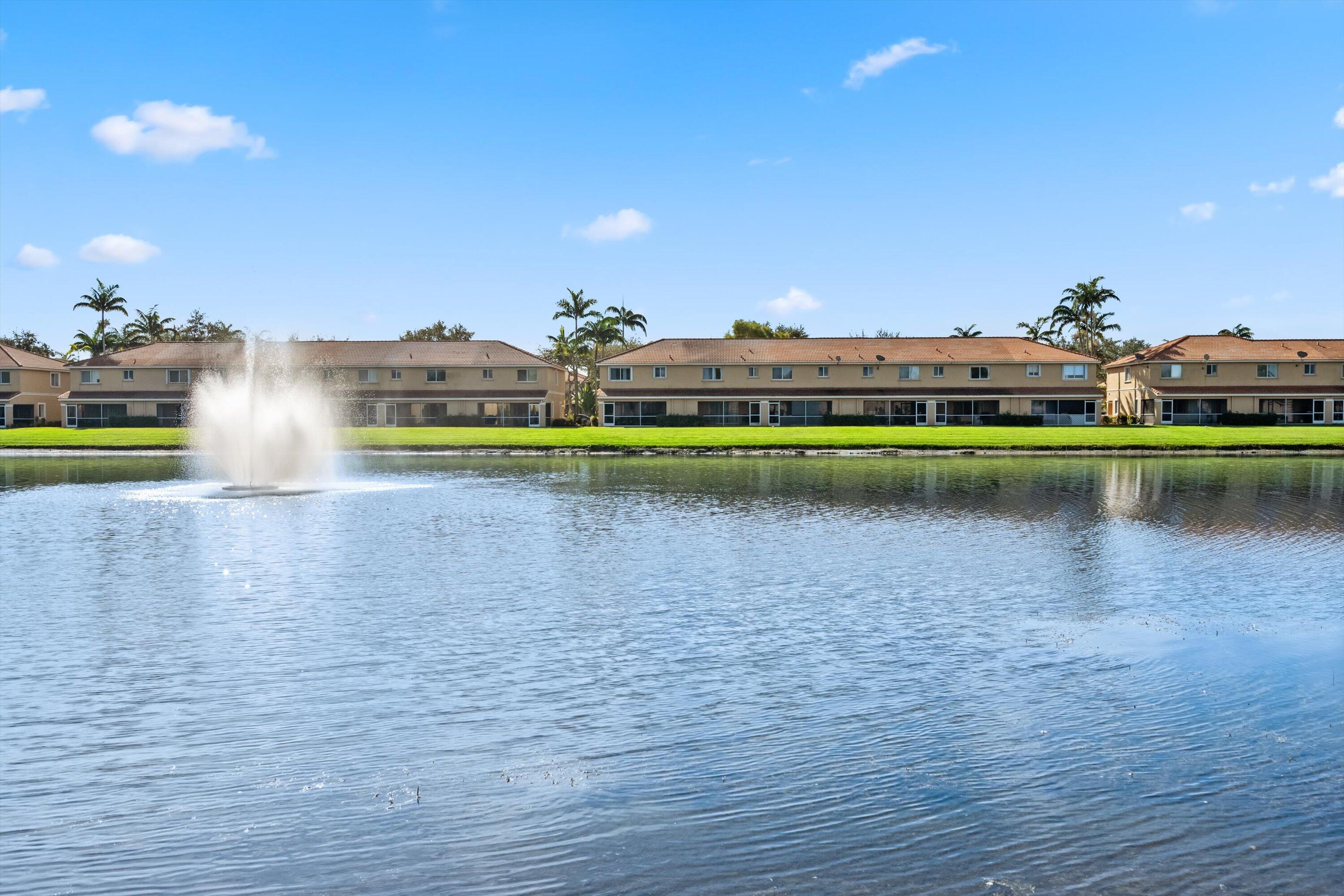 3486 Briar Bay Boulevard, Unit 101 West Palm Beach, FL 33411 - Photo 34 of 46 a view of a swimming pool and a yard