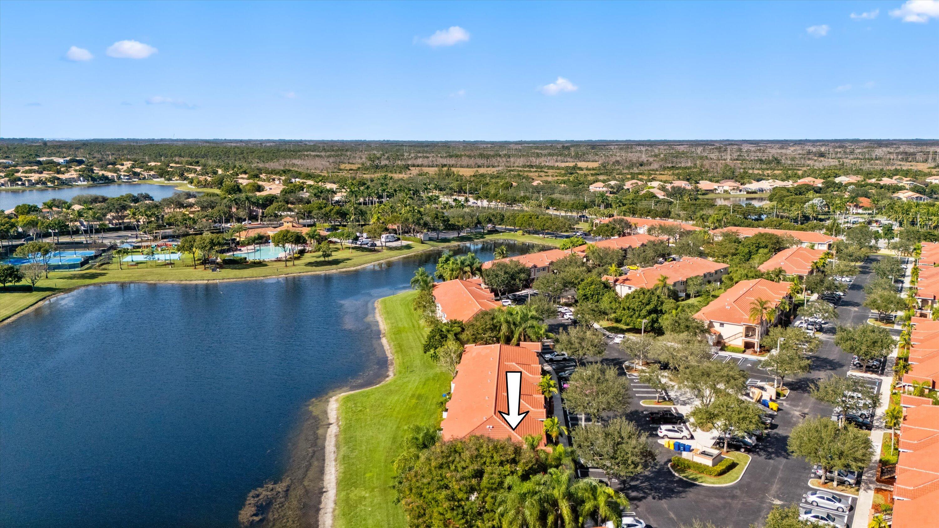 3486 Briar Bay Boulevard, Unit 101 West Palm Beach, FL 33411 - Photo 40 of 46 an aerial view of residential houses with outdoor space and swimming pool
