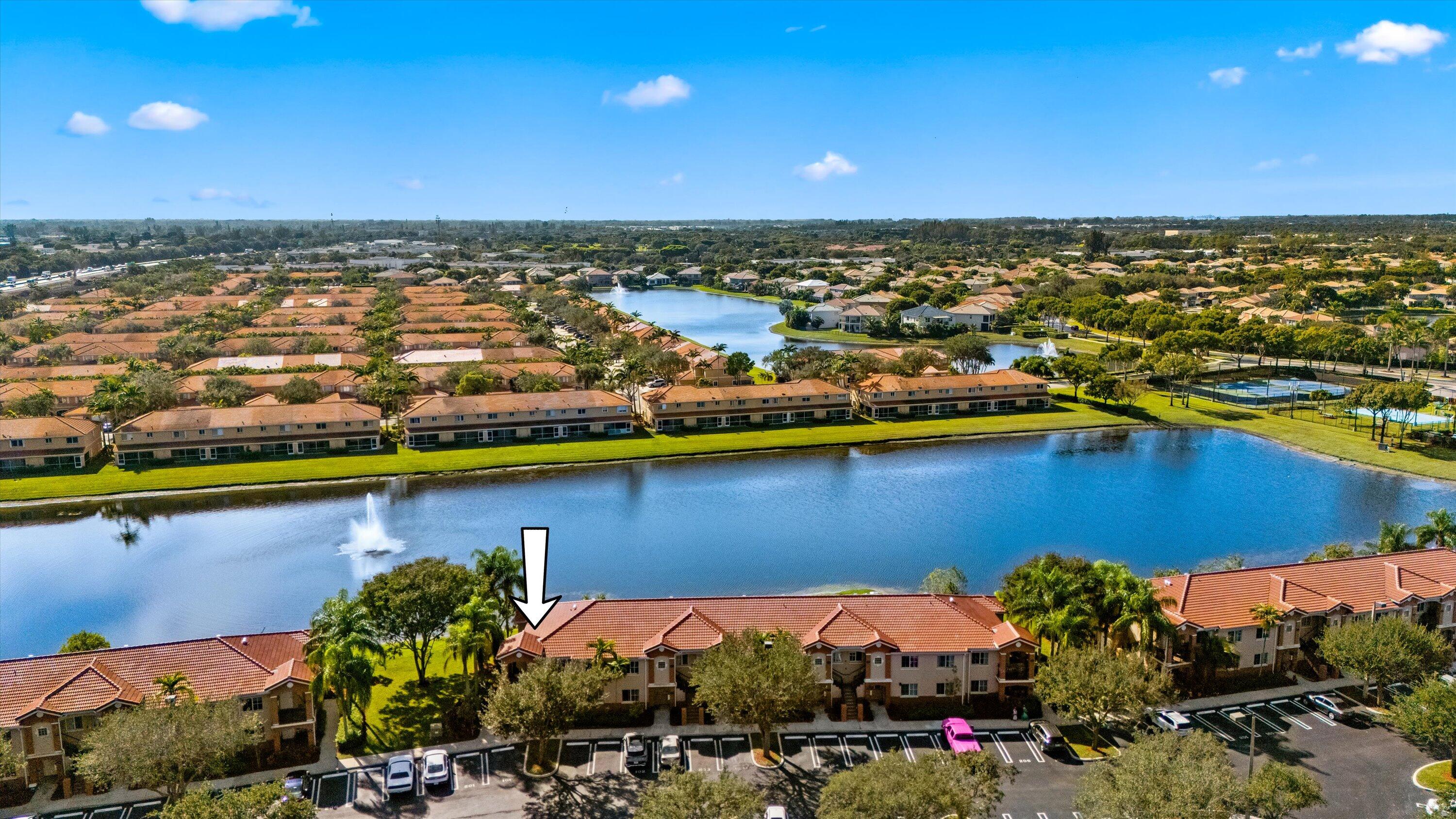 3486 Briar Bay Boulevard, Unit 101 West Palm Beach, FL 33411 - Photo 42 of 46 an aerial view of residential houses with outdoor space and lake view