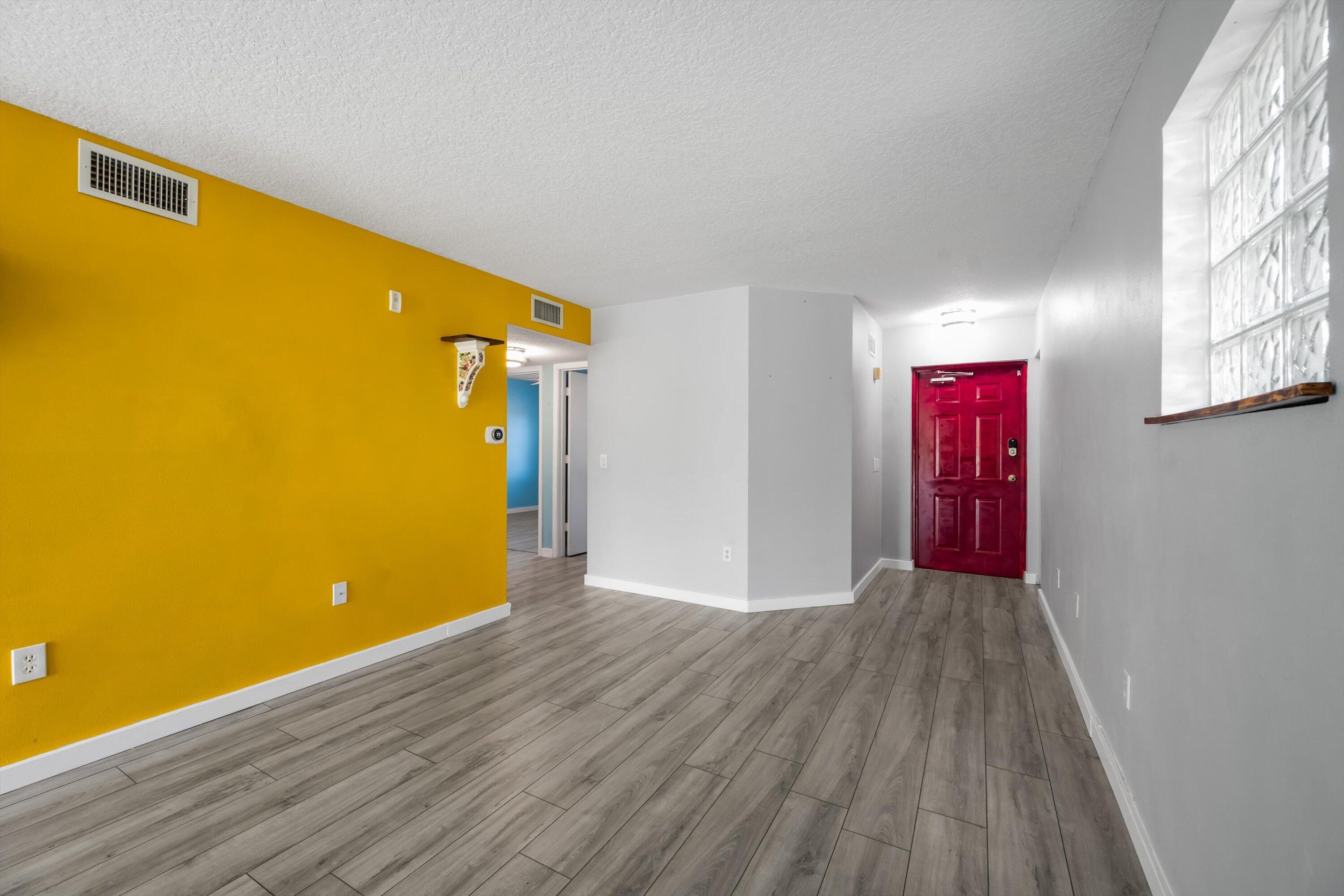 3486 Briar Bay Boulevard, Unit 101 West Palm Beach, FL 33411 - Photo 10 of 46 a view of a room with wooden floor and a ceiling fan