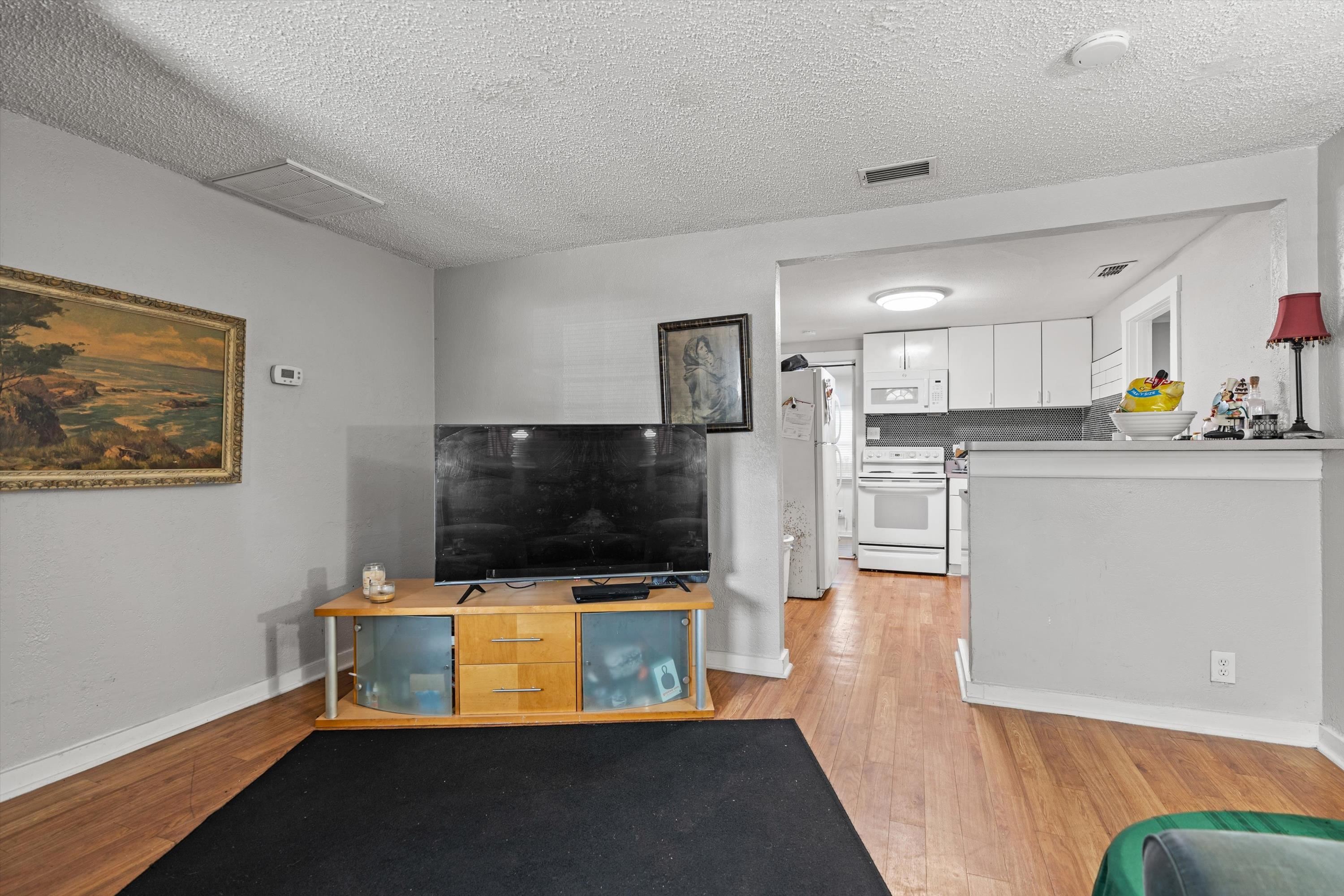 4588 First Avenue St. Augustine, FL 32095 - Photo 14 of 25 a living room with stainless steel appliances kitchen island granite countertop a stove and a microwave