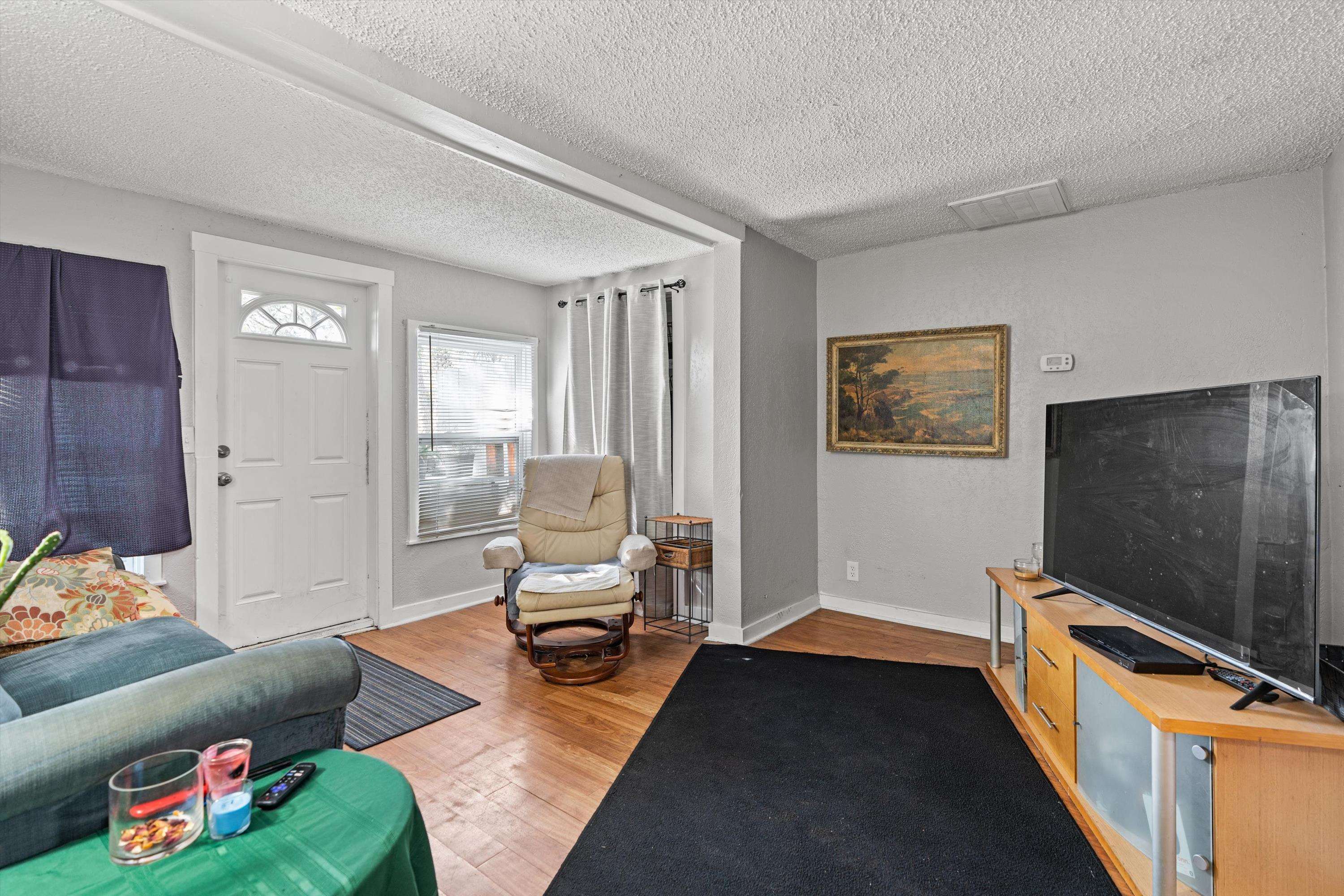 4588 First Avenue St. Augustine, FL 32095 - Photo 15 of 25 a living room with furniture and a flat screen tv