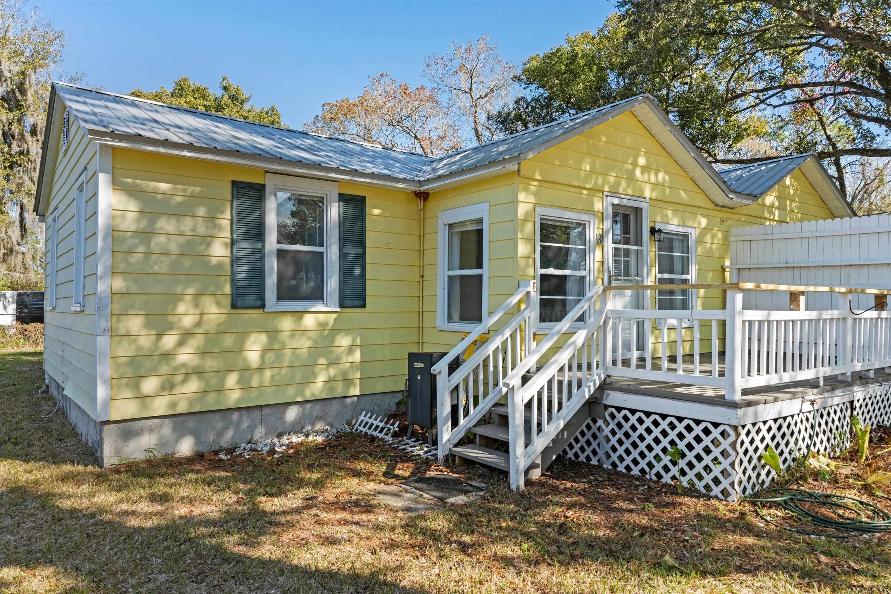 4588 First Avenue St. Augustine, FL 32095 - Photo 2 of 25 a front view of a house with a yard