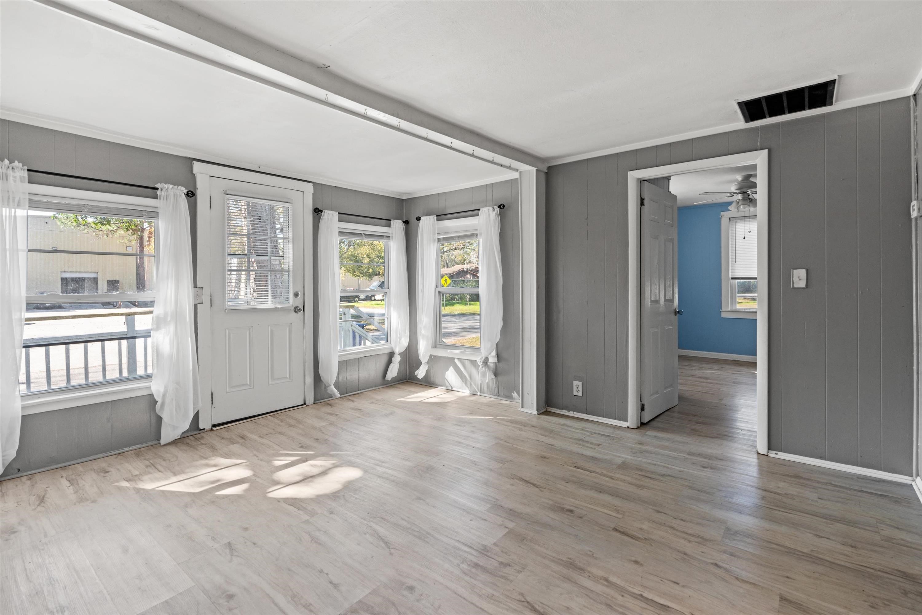 4588 First Avenue St. Augustine, FL 32095 - Photo 4 of 25 an empty room with wooden floor and windows