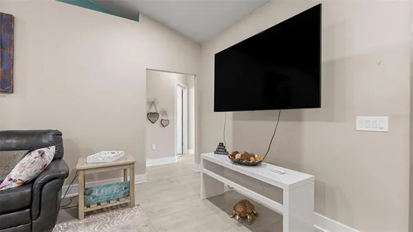 a room with a flat screen tv and a couch
