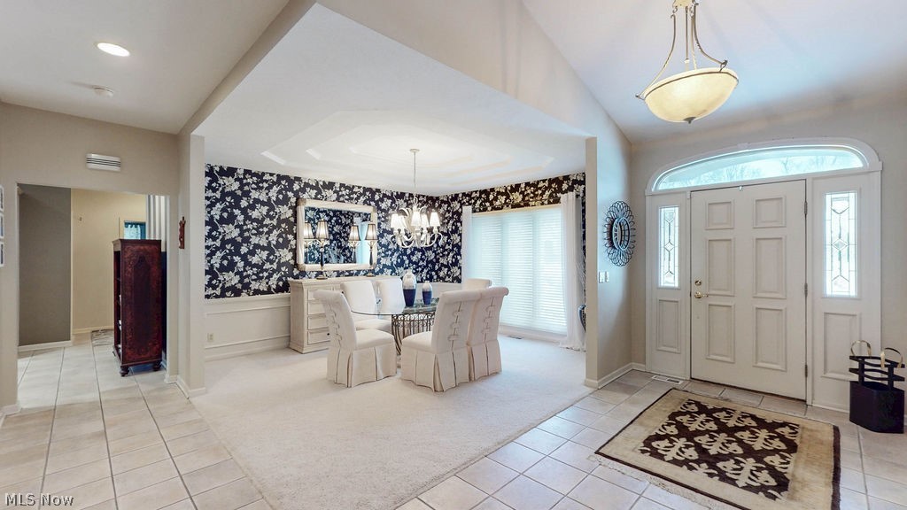 36845 Aberdeen Lane Solon, OH 44139 - Photo 3 of 24 Entryway featuring light carpet, a chandelier, light tile patterned floors, wallpapered walls, and a wainscoted wall