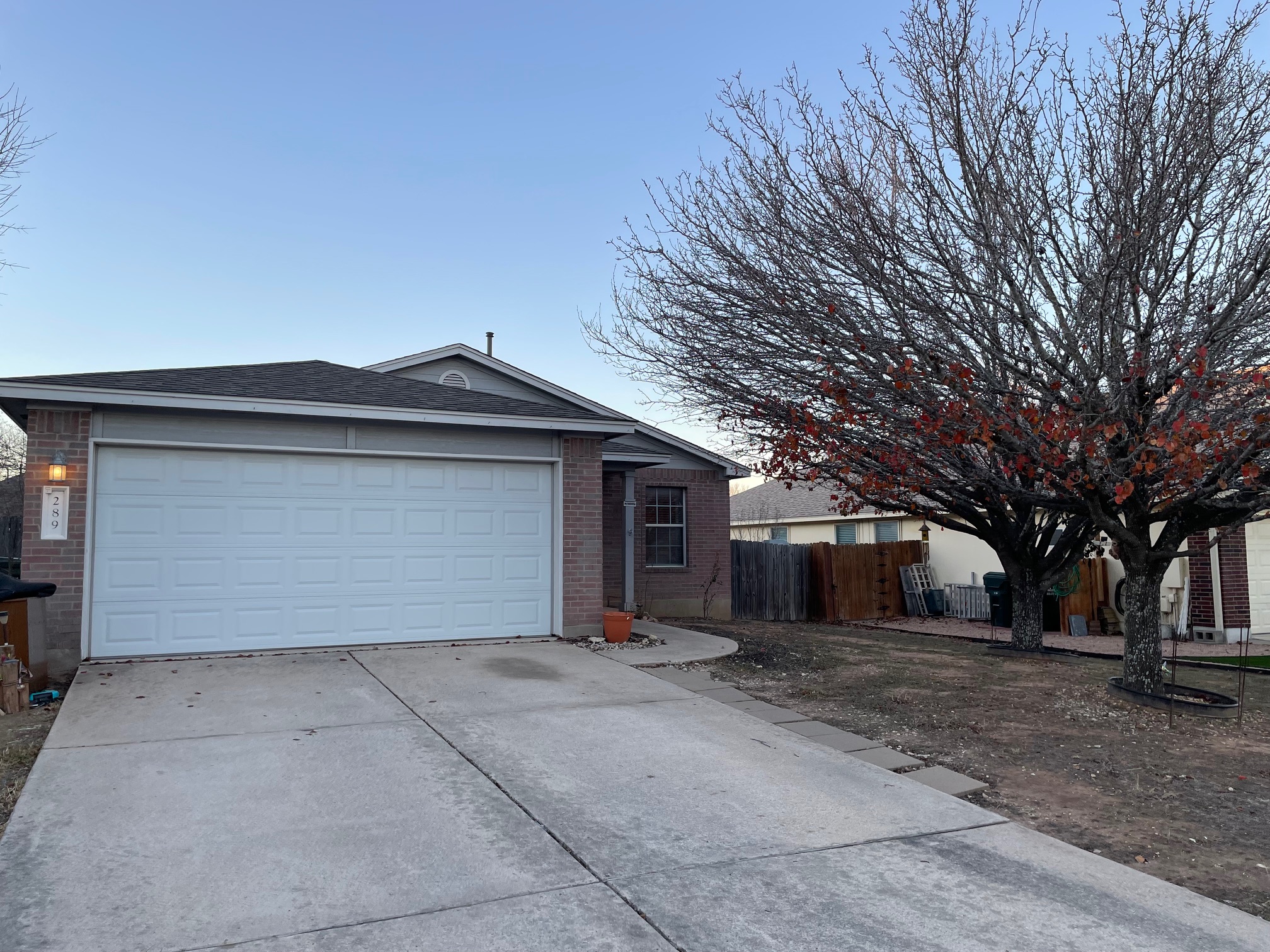 Home with brick siding, concrete driveway, and a garage