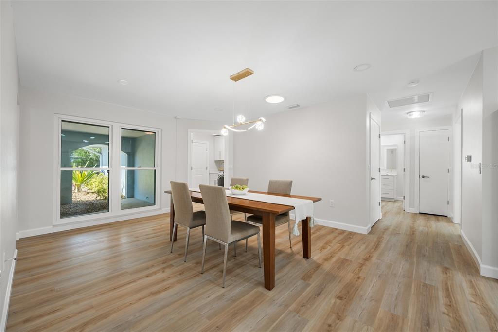 656 Mehlenbacher Road Belleair, FL 33756 - Photo 8 of 49 a view of a dining room with furniture and a wooden floor