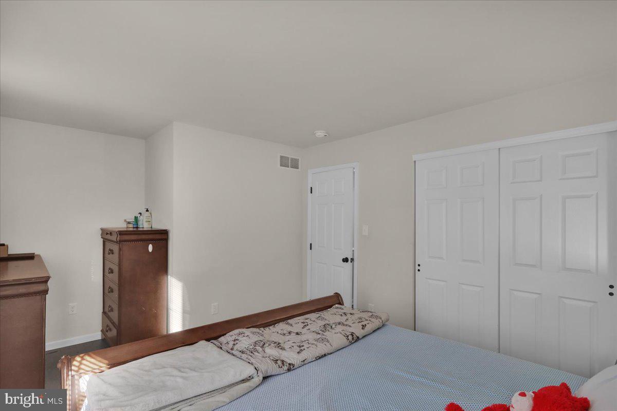 383 Oneida Drive Reading, PA 19608 - Photo 15 of 27 a bedroom with a bed and a mirror