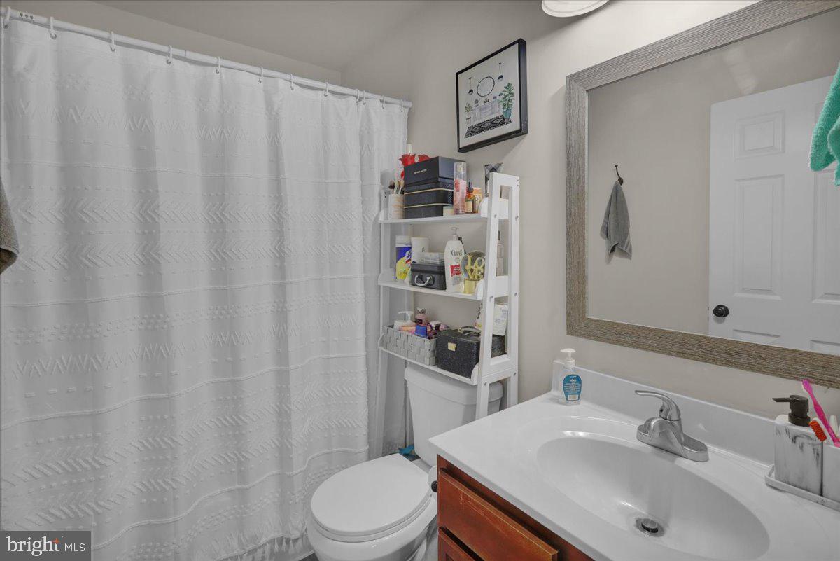 383 Oneida Drive Reading, PA 19608 - Photo 19 of 27 a bathroom with a sink a toilet and shower curtain
