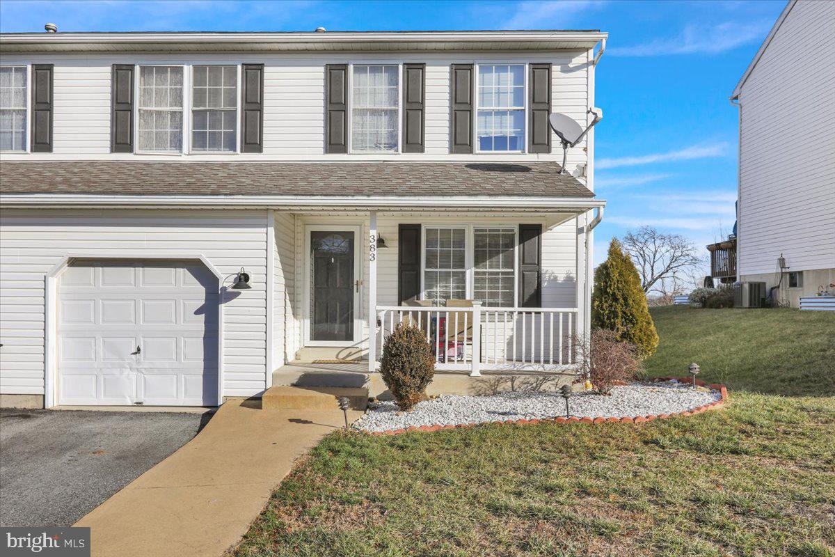 383 Oneida Drive Reading, PA 19608 - Photo 2 of 27 a front view of a house with a garden and yard
