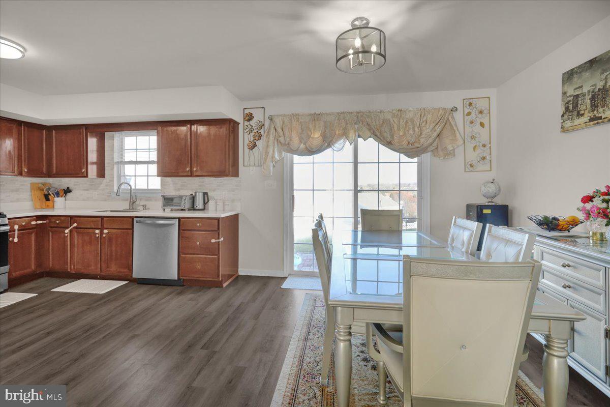 383 Oneida Drive Reading, PA 19608 - Photo 5 of 27 a kitchen with a table chairs refrigerator and microwave