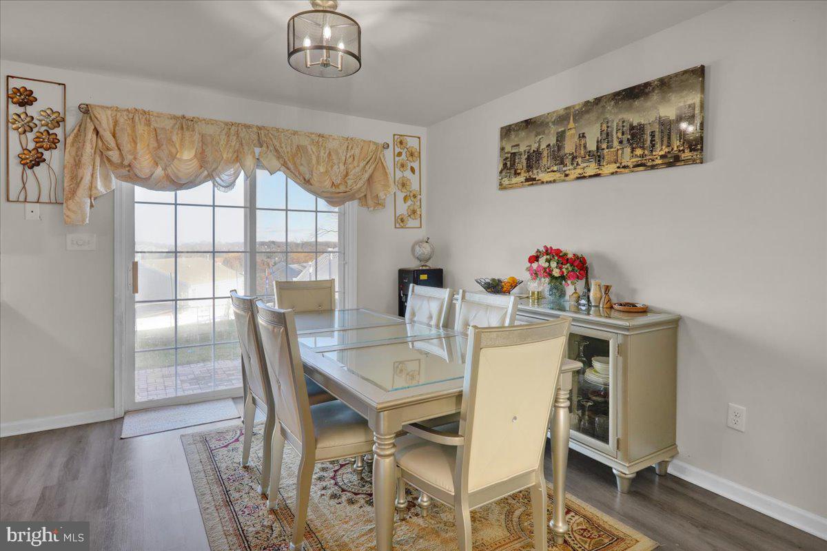 383 Oneida Drive Reading, PA 19608 - Photo 6 of 27 a view of a dining room with furniture a chandelier and wooden floor