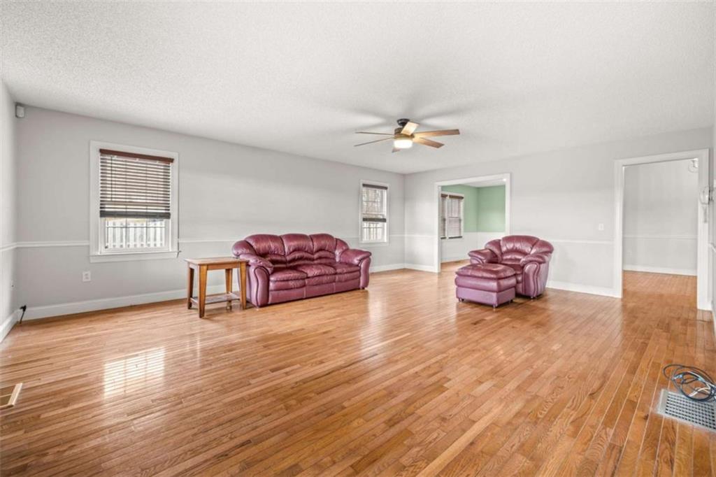 131 Caudell Drive Lula, GA 30554 - Photo 16 of 45 a living room with furniture and a wooden floor