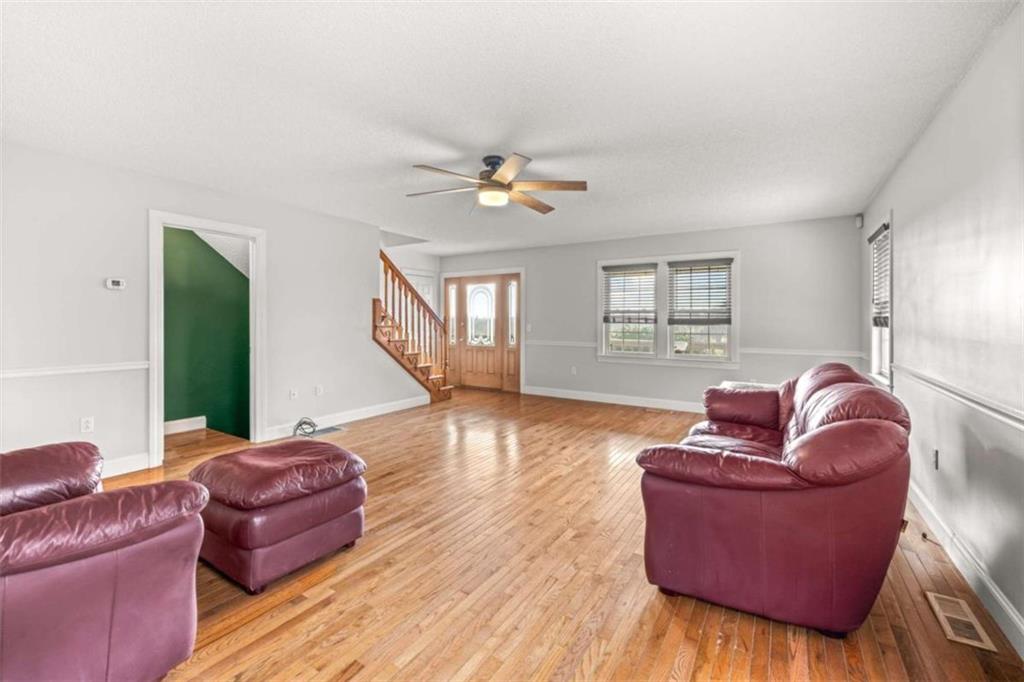 131 Caudell Drive Lula, GA 30554 - Photo 17 of 45 a living room with furniture and a wooden floor