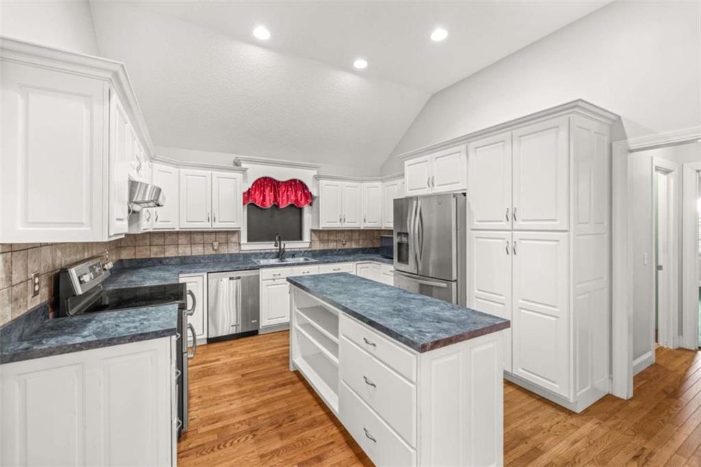 131 Caudell Drive Lula, GA 30554 - Photo 20 of 45 a kitchen with stainless steel appliances granite countertop a kitchen island a stove a refrigerator and a sink