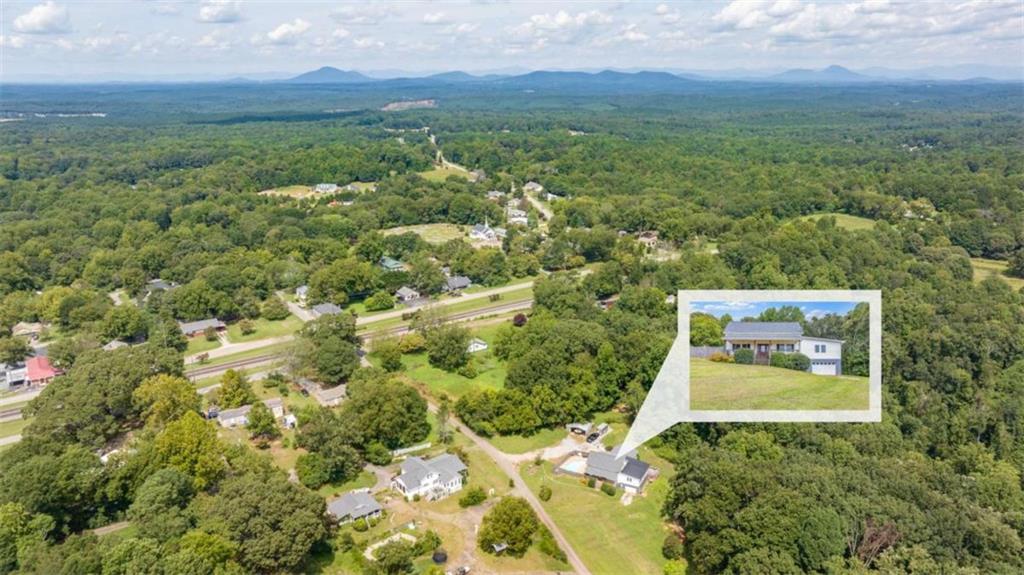131 Caudell Drive Lula, GA 30554 - Photo 3 of 45 a view of a city with lush green forest