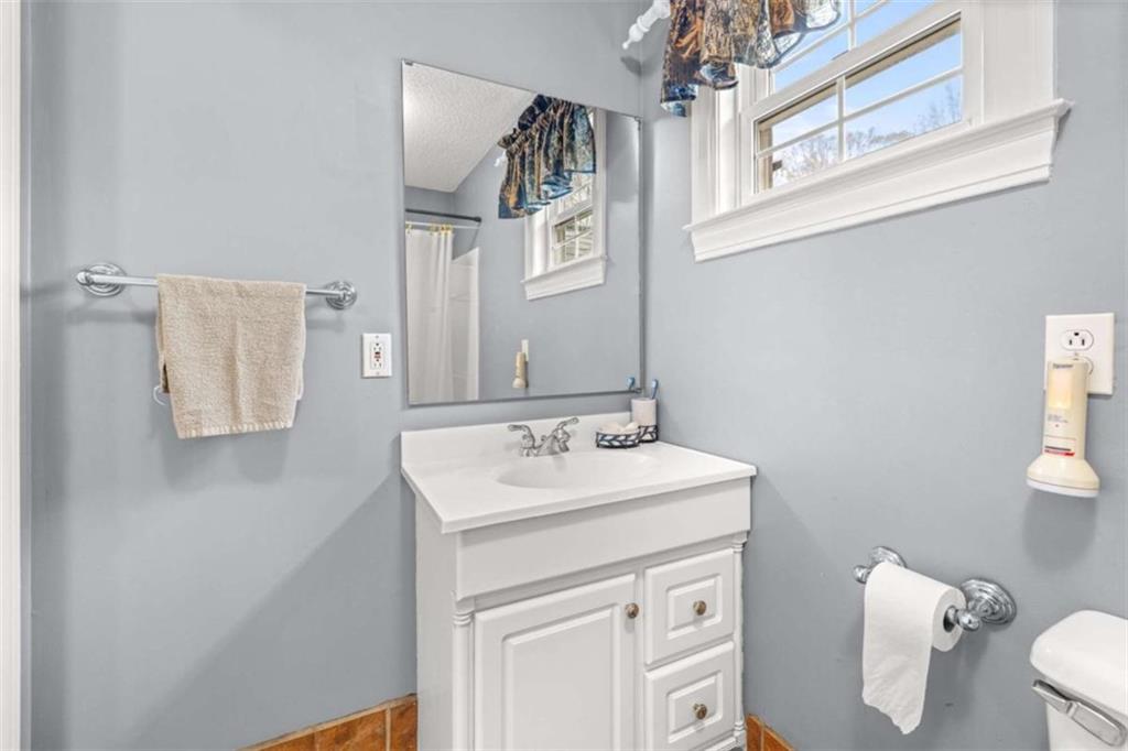 131 Caudell Drive Lula, GA 30554 - Photo 32 of 45 a bathroom with a sink a toilet and mirror