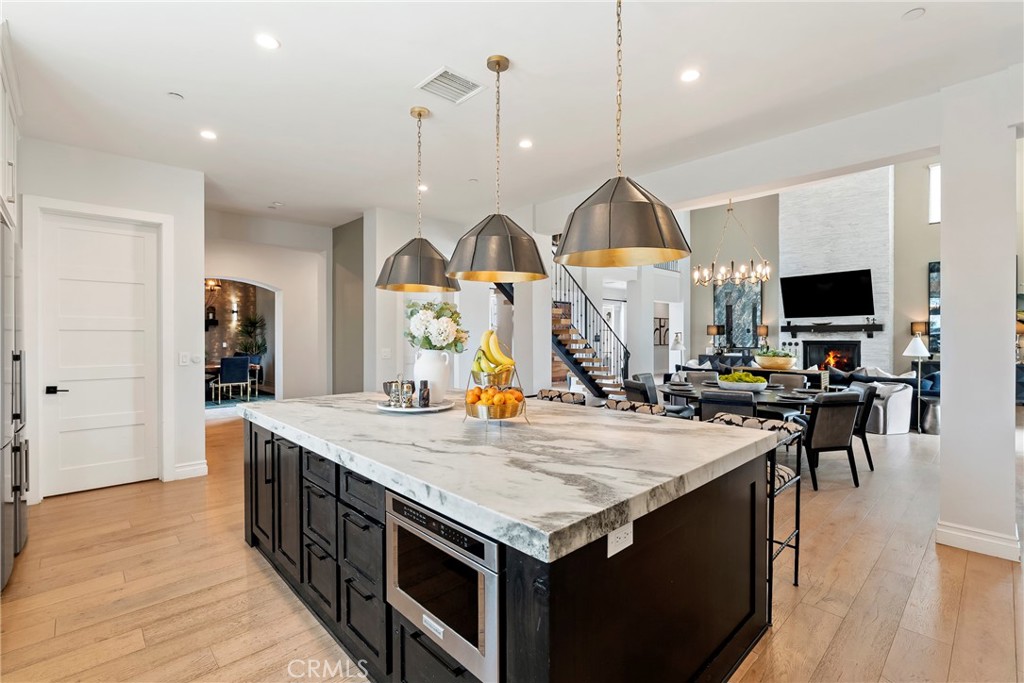 27716 Sycamore Mesa Road Temecula, CA 92590 - Photo 17 of 73 a kitchen with stainless steel appliances kitchen island a table and chairs in it