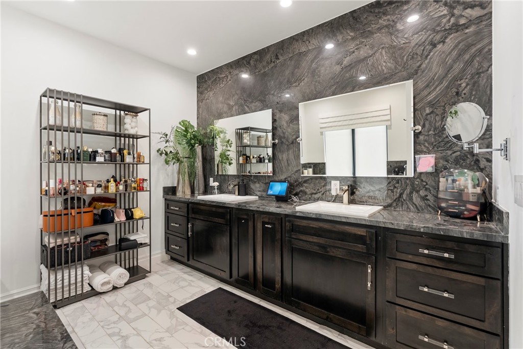 27716 Sycamore Mesa Road Temecula, CA 92590 - Photo 45 of 73 a spacious bathroom with a double vanity sink and a mirror