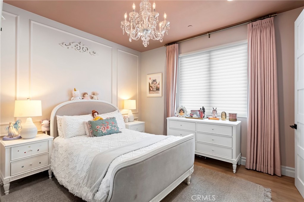 27716 Sycamore Mesa Road Temecula, CA 92590 - Photo 53 of 73 a bedroom with a bed and a chandelier