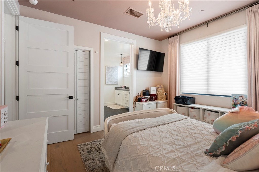 27716 Sycamore Mesa Road Temecula, CA 92590 - Photo 54 of 73 a bedroom with a bed and a chandelier