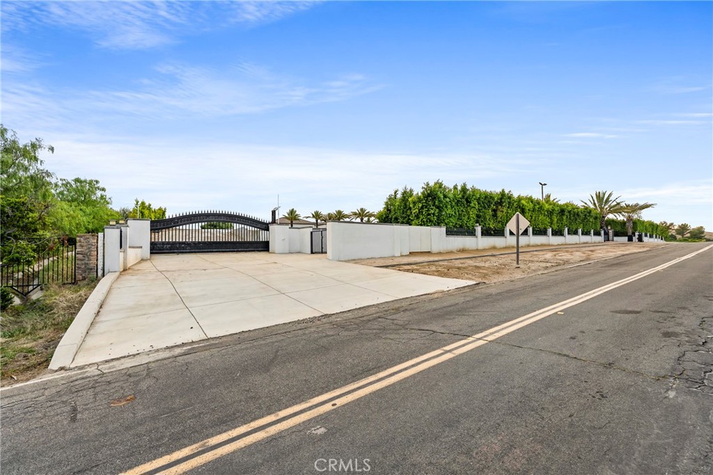 27716 Sycamore Mesa Road Temecula, CA 92590 - Photo 70 of 73 a white house with a yard and wooden fence