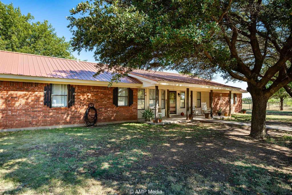 210 Foothill Road Abilene, TX 79602 - Photo 1 of 1 Ranch-style house with covered porch, a metal roof, brick siding, and a front yard