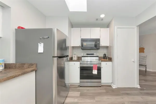a kitchen with a refrigerator and a sink