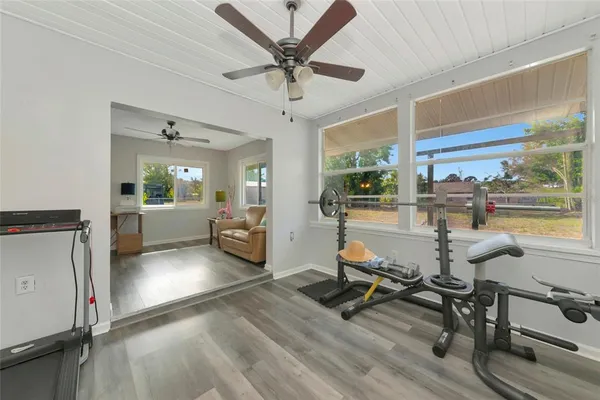 a living room with furniture and a wooden floor