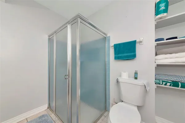 a white toilet sitting next to a bathroom sink