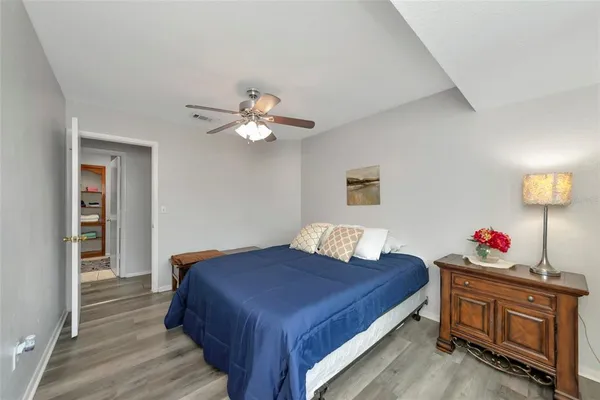 a bedroom with a bed and a chandelier