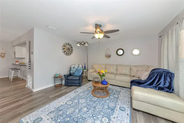 a living room with furniture and wooden floor