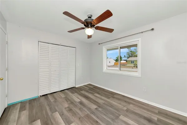 a view of workspace with wooden floor and ceiling fan