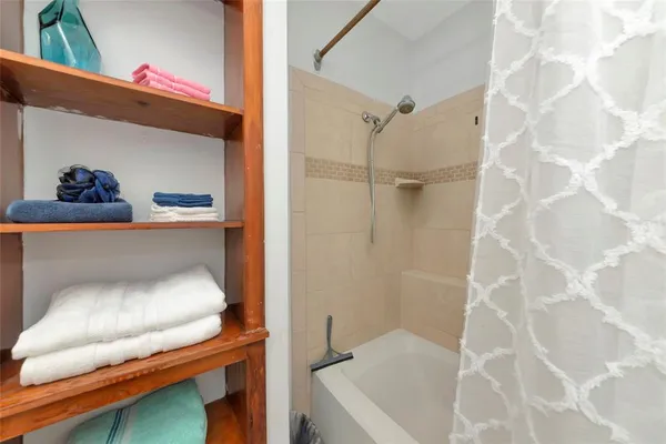 a bathroom with a tub and a shower