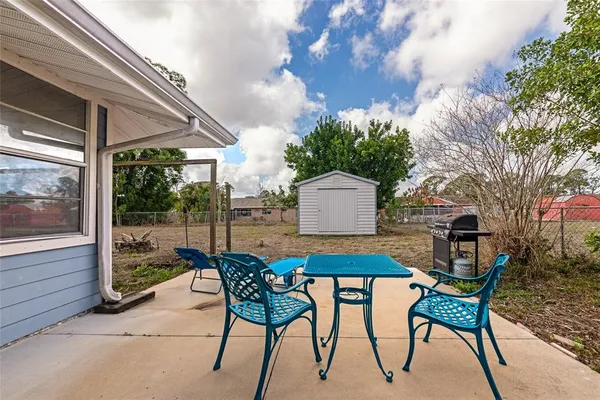 a outdoor space with a table and chairs