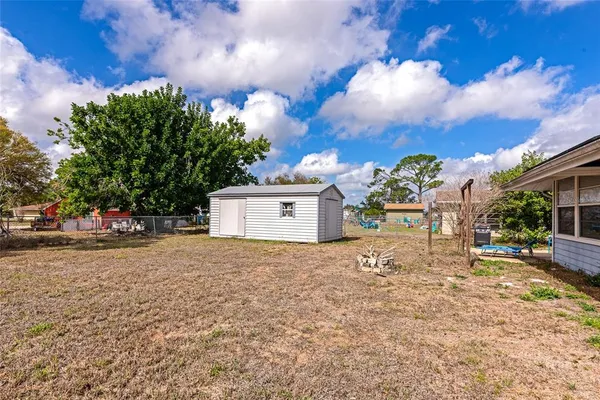 a view of yellow house with a yard