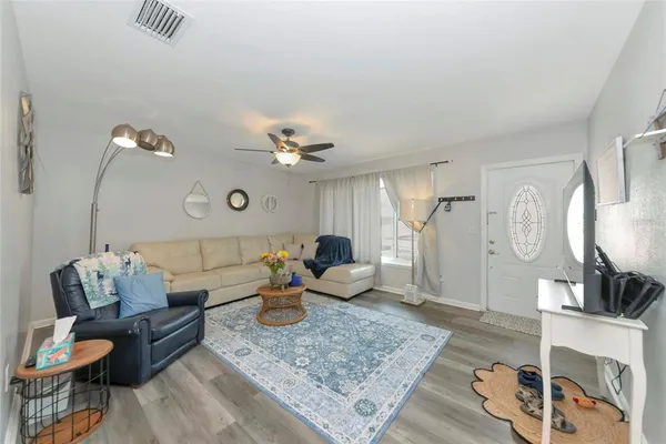 a living room with furniture and wooden floor