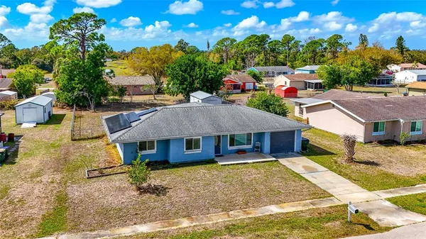 an aerial view of a house with a yard pool outdoor seating and yard